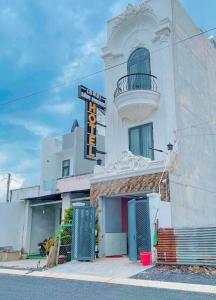 a white building with a sign in front of it at Lâm Phong Hotel in Tây Ninh