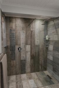 a bathroom with a shower with a wooden wall at Welverdiend - Unit 1 in Bloemfontein +86 photos