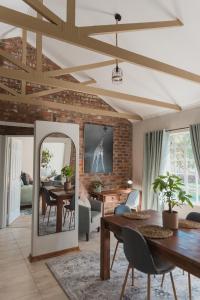 a living room with a table and a mirror at Welverdiend - Unit 1 in Bloemfontein