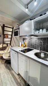 a kitchen with white cabinets and a sink at Sleep with the stars in Oslo