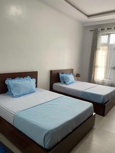 Postel nebo postele na pokoji v ubytování maman home apartment