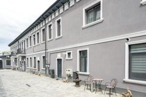 a building with chairs and a table in front of it at Hotel Avner in Bucharest