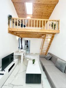 a living room with a couch and a loft at Hotel Avner in Bucharest