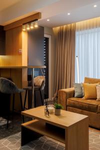 a living room with a couch and a table at Renest New York Skyline View in Chişinău