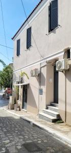 a building on the side of a street next to a building at Harmony Apartment Pythagoreio Samos Center in Pythagoreio
