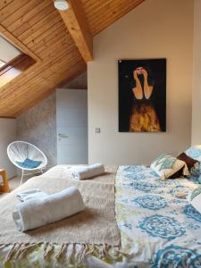 a bedroom with a large bed and a painting on the wall at Holiday Home Le Holset in Durbuy