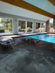 a large swimming pool in a house at Holiday Home Le Holset in Durbuy