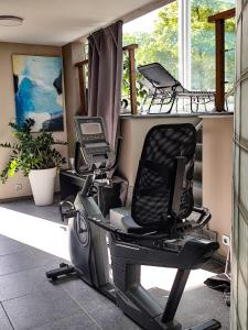 a gym with a chair and a computer on a balcony at Holiday Home Le Holset in Durbuy +36 photos