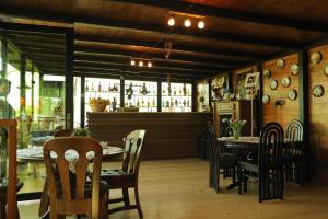 a dining room with a table and chairs and a bar at Panorama Sormoni in Dzhimastaro
