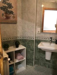 a bathroom with a sink and a toilet and a mirror at coparelia 2 in Villarrobledo +5 photos