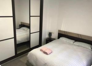 a bedroom with a white bed and a mirror at coparelia 2 in Villarrobledo +5 photos
