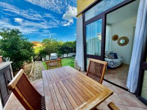 a wooden table and chairs on a patio at La Casa al Mare in Cannigione