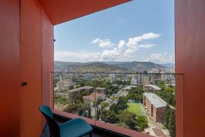 a window with a view of a city at Hilton Blox Avlabari Apartment in Tbilisi City