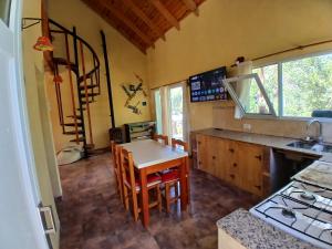 eine Küche mit Tisch und Stühlen in einem Zimmer in der Unterkunft El Jardin de Sauce in Monte Hermoso