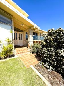 a house with a brick walkway leading to the front door at 24 Sorrento Seabreeze 5br Family Seaside Home in Perth
