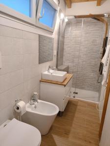 a bathroom with a sink and a toilet and a sink at Iris Cottage in Anzola dell'Emilia