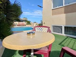 a table and chairs with a bowl on top of it at Private Flatlet in a Villa with Pool - 6 Guests Max in Naxxar
