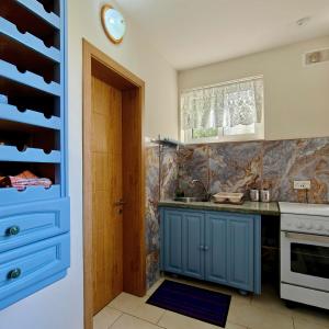 a kitchen with blue cabinets and a blue door at Private Flatlet in a Villa with Pool - 6 Guests Max in Naxxar
