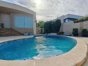 a swimming pool in front of a house at Private Flatlet in a Villa with Pool - 6 Guests Max in Naxxar +6 photos