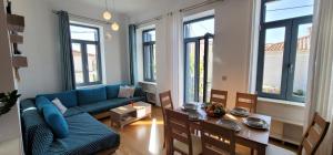 a living room with a blue couch and a table at Harmony Apartment Pythagoreio Samos Center in Pythagoreio