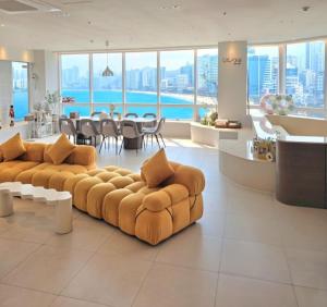 a living room with two couches and a table at TheVibe Gwangan-Grand Oceanview Private Villa in Kwangan-dong