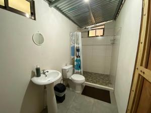 a bathroom with a toilet and a sink and a shower at Cabin -Treehouse La Tigra in San Gerardo +35 photos
