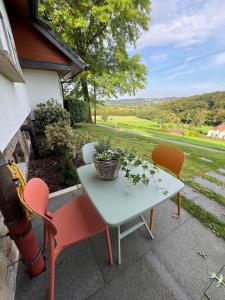 a table and chairs on a patio with a view at Appartement am Rüsberg in Witten