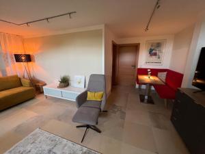 a living room with a couch and a chair at Appartement am Rüsberg in Witten +3 photos