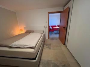 a bedroom with a bed and a table with a chair at Appartement am Rüsberg in Witten