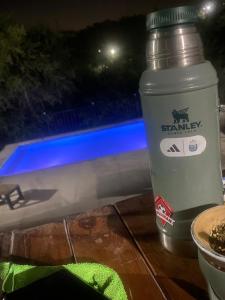 a bottle of water sitting on a table next to a table at La curva del molino in Villa Parque Siquiman