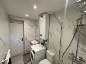 a bathroom with a toilet and a glass shower at Pavillion Peuple de l'Herbe in Carrières-sous-Poissy +4 photos