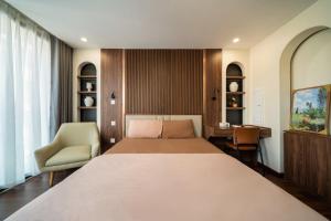 a bedroom with a large bed and a desk at HNT Homestay Đào Tấn - Near Lotte Center in Hanoi