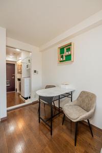 a dining room with a table and two chairs at sakura 403 in Tokyo