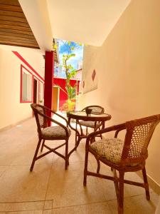a room with two chairs and a table and a window at Pousada Solana in Salvador
