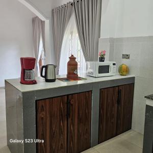 a kitchen with a counter top with a microwave at Moon Guest House in Trincomalee +12 photos