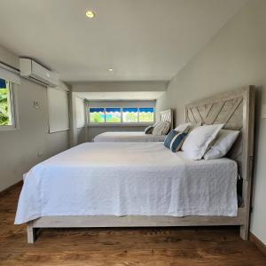 a large white bed in a bedroom with a window at Villa Dominique in Villas del Mar +10 photos