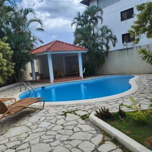 a swimming pool with a gazebo next to a house at Villa Dominique in Villas del Mar