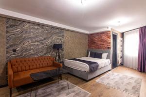 a bedroom with a bed and a couch at Nomad Hub Suit İstanbul in Istanbul +80 photos