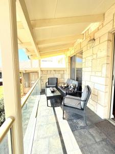 a patio with two chairs and a table at 24 Sorrento Seabreeze 5br Family Seaside Home in Perth