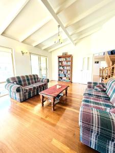 a living room with two couches and a coffee table at 24 Sorrento Seabreeze 5br Family Seaside Home in Perth