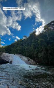 a view of a river with people in the water at ALTO DA COLINA LOCAÇÃO COM KITNETES e INFRA - Próximo do Centro de Penedo in Penedo