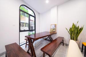 a table and benches in a room with a window at HNT Homestay Đào Tấn - Near Lotte Center in Hanoi +35 photos