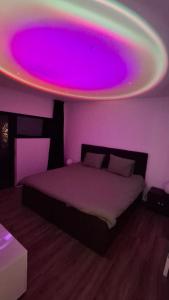 a bedroom with a bed with a purple light at Vichte groundfloor apartment 