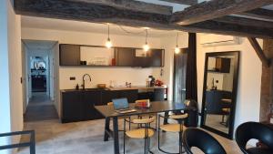 a kitchen and dining room with a table with a laptop on it at Vichte groundfloor apartment 