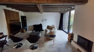 a living room with a couch and chairs and a tv at Vichte groundfloor apartment 