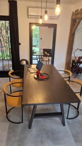 a dining room table with chairs and a laptop on it at Vichte groundfloor apartment  +7 photos