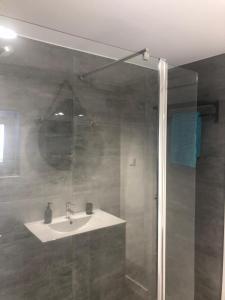 a bathroom with a sink and a shower at Casa da Oliveira 