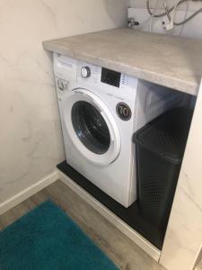 a washer and dryer under a counter in a bathroom at Casa da Oliveira  +1 photo