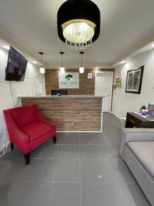 a living room with a red chair and a counter at Oak Tree Inn in Irvine