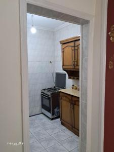 a kitchen with a stove and an open doorway at شقة بحر إسكندرية Bianchi Breeze in Alexandria